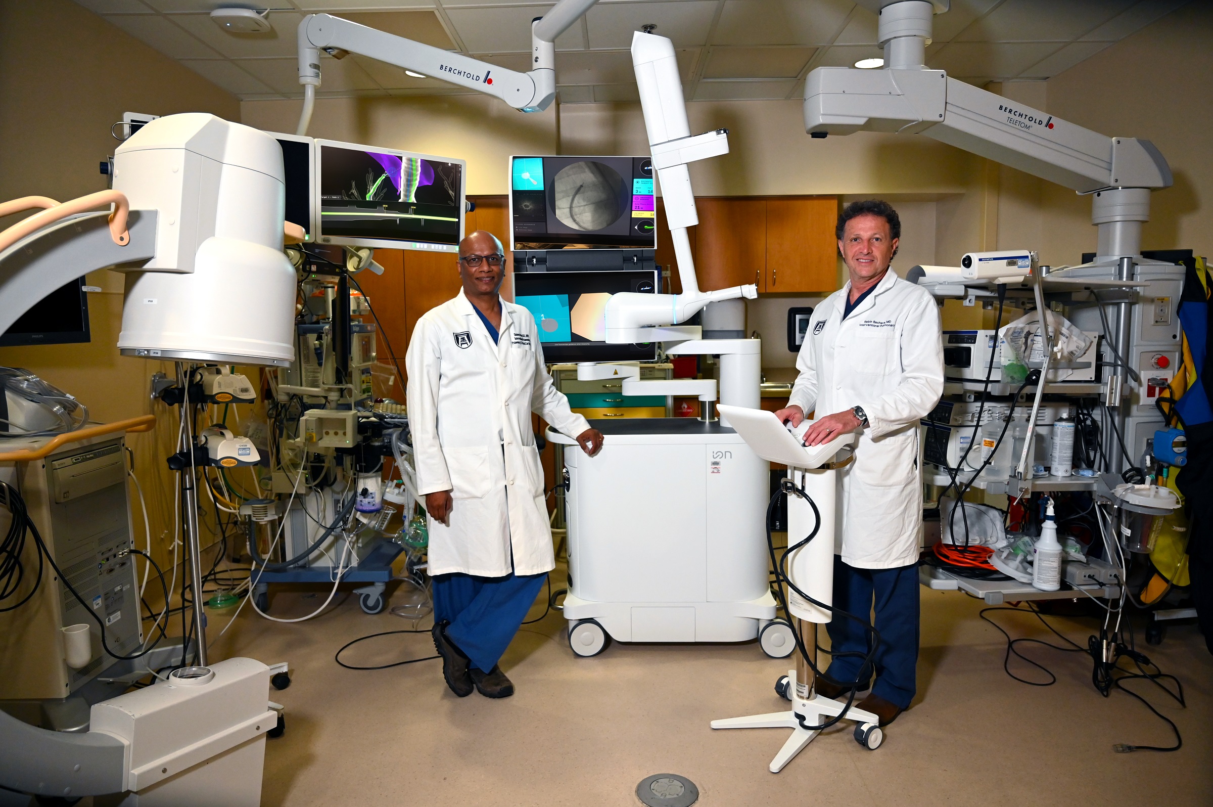 Two men standing in front of hospital equipment