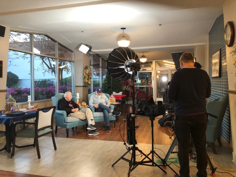 Crew filming two men in armchairs