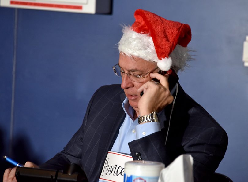 Man in Santa hat on phone