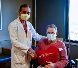 Doctor shaking hand of man in wheelchair 